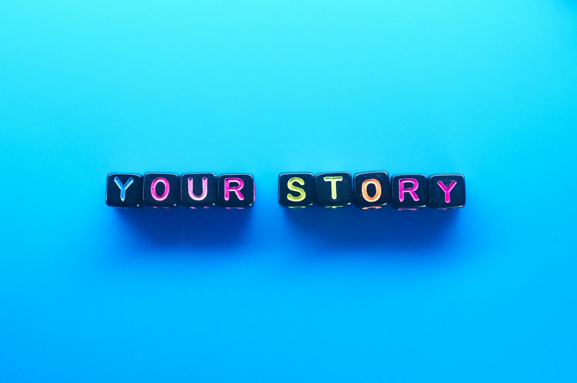 small black cube with the word your story